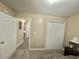 Neutral bedroom featuring plush carpet, closet, and an open doorway to the rest of the house at 3677 Claypond Village Ln. # 4, Myrtle Beach, SC 29572