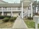 Charming condo entrance featuring a white door, and well-maintained landscaping at 3677 Claypond Village Ln. # 4, Myrtle Beach, SC 29572