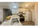 Bright kitchen with white cabinetry, stainless steel appliances, and breakfast bar at 3677 Claypond Village Ln. # 4, Myrtle Beach, SC 29572