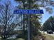 Blue sign reading Claypond Village Ln with trees and blue sky in the background at 3677 Claypond Village Ln. # 4, Myrtle Beach, SC 29572