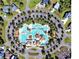 Aerial view of a resort-style community pool with landscaped surroundings and ample parking at 381 Starlit Way, Myrtle Beach, SC 29579