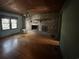 Living room featuring a brick fireplace, hardwood floors, and a window providing natural light at 402 Wilkinson St., Georgetown, SC 29440