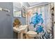 Blue bathroom with a pedestal sink and a sea turtle themed shower curtain at 408 Sunset Trail, Myrtle Beach, SC 29577