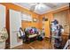 Orange bedroom features hardwood floors, ceiling fan, and window with blinds at 408 Sunset Trail, Myrtle Beach, SC 29577