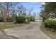 Home exterior featuring a long driveway leading to a detached two-car garage at 408 Sunset Trail, Myrtle Beach, SC 29577