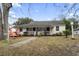 Charming single-story home with a cozy front porch and mature trees at 408 Sunset Trail, Myrtle Beach, SC 29577