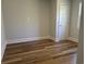 This bedroom features light gray walls, white trim, luxury vinyl plank flooring, and a white door at 415 Circle Dr., Johnsonville, SC 29555