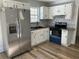 Modern kitchen with stainless steel appliances, white cabinets, and stylish backsplash at 415 Circle Dr., Johnsonville, SC 29555