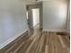 Bright living room with wood-look flooring and neutral wall paint at 415 Circle Dr., Johnsonville, SC 29555