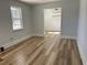 Bright living room with wood-look flooring and neutral wall paint and window at 415 Circle Dr., Johnsonville, SC 29555