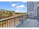 Balcony with black iron railing overlooking a quiet street, trees, and with partial beach views at 423 Parker Dr. # 306, Pawleys Island, SC 29585