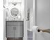 Bathroom featuring a gray vanity with stylish round mirror, and bronze fixtures at 423 Parker Dr. # 306, Pawleys Island, SC 29585