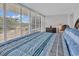 Bedroom with wood floors, natural light, shuttered windows and neutral decor at 423 Parker Dr. # 306, Pawleys Island, SC 29585