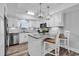 Bright kitchen with stainless steel appliances, a center island with barstool seating, and white cabinetry at 423 Parker Dr. # 306, Pawleys Island, SC 29585