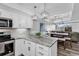 Open-concept kitchen with stainless appliances, stone countertops, and pendant lighting at 423 Parker Dr. # 306, Pawleys Island, SC 29585