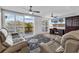 Living room featuring a desk, built-in cabinet, wall-mounted TV, and sliding glass doors to balcony at 423 Parker Dr. # 306, Pawleys Island, SC 29585