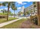 Resort pool area with lounge chairs and palm trees in a lush landscape setting at 423 Parker Dr. # 306, Pawleys Island, SC 29585