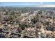 Aerial view of a quaint neighborhood near the ocean showcasing mature trees, houses, and blue skies at 4305 Frontier Dr., Myrtle Beach, SC 29577