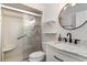 Bathroom featuring tiled shower, marble vanity with modern faucet, and round mirror at 4305 Frontier Dr., Myrtle Beach, SC 29577