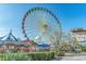 Amusement park featuring Ferris wheel, beachside swings, lush greenery, and pathways at 4305 Frontier Dr., Myrtle Beach, SC 29577