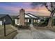 A charming home exterior is enhanced by a brick chimney and manicured bushes at 4305 Frontier Dr., Myrtle Beach, SC 29577