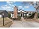 A charming home exterior is enhanced by a brick chimney and manicured bushes at 4305 Frontier Dr., Myrtle Beach, SC 29577