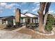 Charming home featuring a brick chimney, black trim, and a cozy front porch with a swing at 4305 Frontier Dr., Myrtle Beach, SC 29577