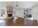 Spacious living room with a brick fireplace, wood floors, and sliding glass doors to the patio at 4305 Frontier Dr., Myrtle Beach, SC 29577