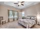 Spacious main bedroom with a tray ceiling, ceiling fan, and abundant natural light at 477 Cane Branch Rd., Loris, SC 29569