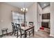 Comfortable dining area featuring a wooden table, modern chandelier, and luxury vinyl plank flooring at 477 Cane Branch Rd., Loris, SC 29569