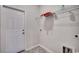 Clean laundry room features storage shelves and easy access with a white door at 477 Cane Branch Rd., Loris, SC 29569