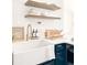 Modern kitchen featuring a farmhouse sink, white countertops, and floating shelves at 4839 Carnation Circle # 303, Myrtle Beach, SC 29577