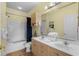 Bathroom featuring a shower-tub combo, double sinks with wooden cabinets, a large mirror and a towel rack at 4843 Luster Leaf Circle # 105, Myrtle Beach, SC 29577