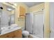 Bathroom features a glass door shower, a single sink with wooden cabinets and a large mirror at 4843 Luster Leaf Circle # 105, Myrtle Beach, SC 29577