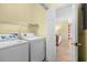 Laundry room featuring a washer, a dryer, and a wire shelf for organizing your laundry accessories at 4843 Luster Leaf Circle # 105, Myrtle Beach, SC 29577