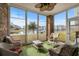 Relaxing sunroom enclosed with brick, wicker seating and views of the pond at 4843 Luster Leaf Circle # 105, Myrtle Beach, SC 29577