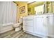 Bathroom featuring a white vanity with drawers, a toilet, and a shower with a curtain at 4935 Crab Pond Ct. # 203, Myrtle Beach, SC 29579