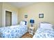 The bedroom offers twin beds with seashell bedding, a side table, and wall art at 4935 Crab Pond Ct. # 203, Myrtle Beach, SC 29579