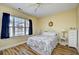 Bedroom with a queen bed, bright window, ceiling fan, and coastal decor at 4935 Crab Pond Ct. # 203, Myrtle Beach, SC 29579