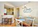 Dining area features a wood table set for four, bar-stool seating, and decorative wall art at 4935 Crab Pond Ct. # 203, Myrtle Beach, SC 29579