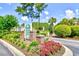 Scenic Windsor Green entrance featuring lush landscaping and community signage at 4935 Crab Pond Ct. # 203, Myrtle Beach, SC 29579