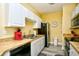 Kitchen with tan countertops, white cabinets, and stainless steel appliances at 4935 Crab Pond Ct. # 203, Myrtle Beach, SC 29579