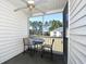 This screened porch provides seating, views of trees and a pond, and a ceiling fan at 4935 Crab Pond Ct. # 203, Myrtle Beach, SC 29579