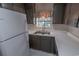 Close-up view of the kitchen with white refrigerator, sink, and dark cabinets at 504 30Th Ave. N # 3, Myrtle Beach, SC 29577