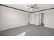 A bright bedroom with white walls, gray carpet, a ceiling fan, and two white paneled doors at 520 Combine Dr., Conway, SC 29527