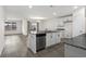 Modern kitchen with an island, stainless steel dishwasher, white cabinets, and a seamless transition into the living area at 520 Combine Dr., Conway, SC 29527