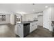 Open kitchen featuring an island with bar seating, white cabinets, stainless steel dishwasher, and sleek gray countertops at 520 Combine Dr., Conway, SC 29527