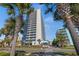 Modern condominium building with multiple balconies and lush palm trees at 5511 N Ocean Blvd. # 1006, Myrtle Beach, SC 29577