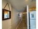 Hallway with tile flooring, decorative mirror, and refrigerator at 5511 N Ocean Blvd. # 1006, Myrtle Beach, SC 29577