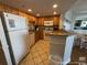 Bright kitchen with white appliances, wooden cabinets, and tile floors at 5511 N Ocean Blvd. # 1006, Myrtle Beach, SC 29577